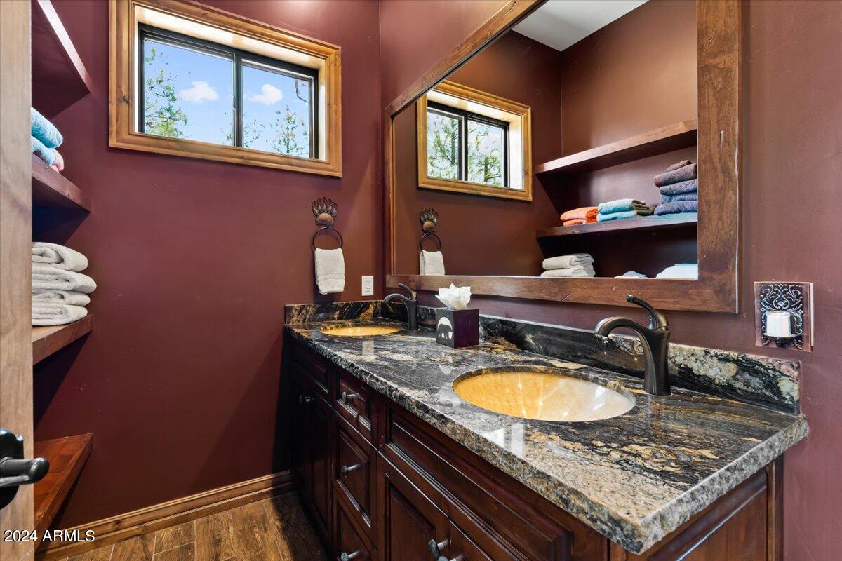 4051 West Falling Leaf Road Show Low, AZ 85901 - Photo 54 of 77 a bathroom with a granite countertop sink a mirror and a window