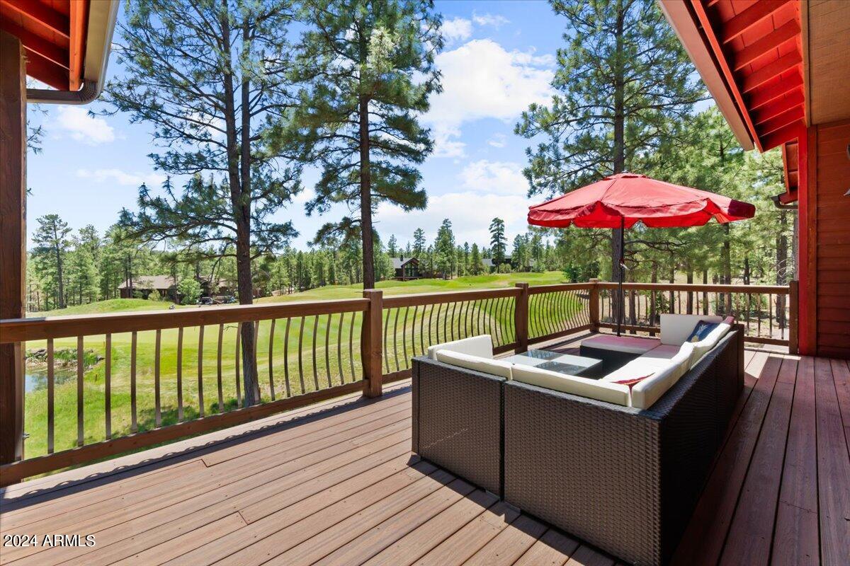 4051 West Falling Leaf Road Show Low, AZ 85901 - Photo 56 of 77 a view of a balcony with wooden floor and outdoor seating