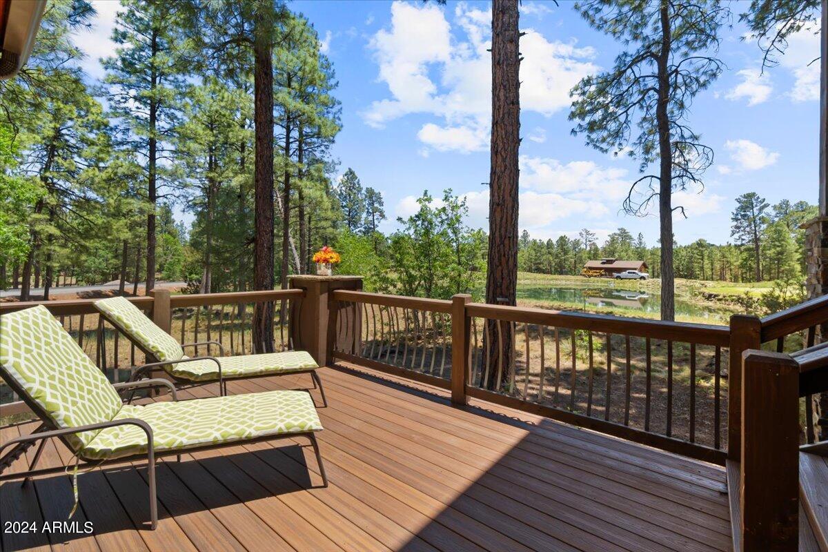 4051 West Falling Leaf Road Show Low, AZ 85901 - Photo 66 of 77 a view of a balcony with wooden floor next to a yard