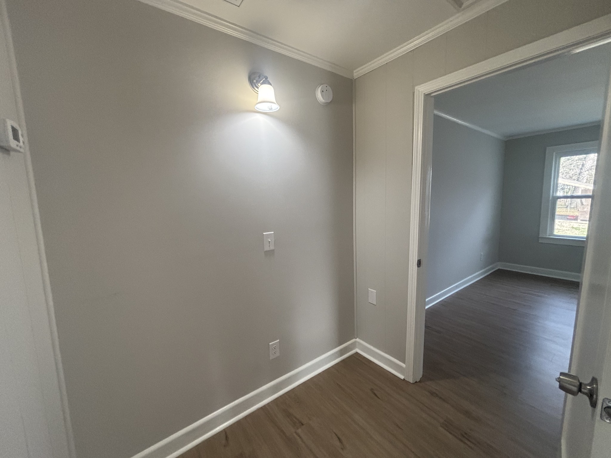 423 South Cedar Lane Pulaski, TN 38478 - Photo 3 of 9 an empty room with wooden floor and windows