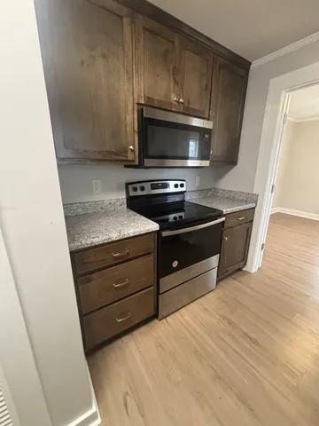 a kitchen with sink microwave and cabinets