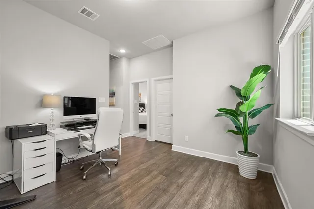 a view of a workspace with furniture and a potted plant