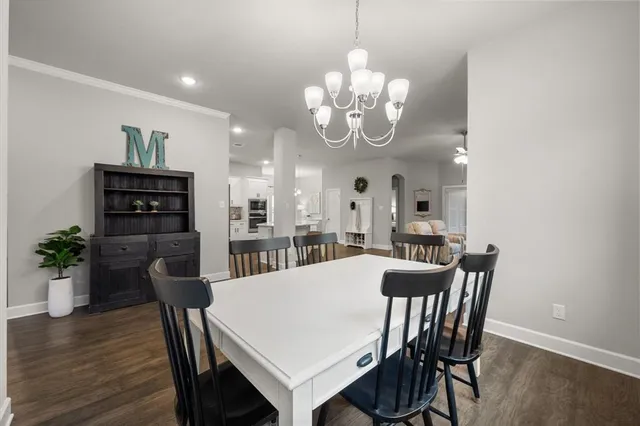 a view of a dining room with furniture wooden floor and chandelier