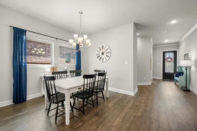 a view of a dining room with furniture wooden floor and chandelier