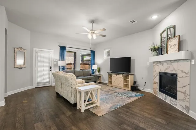 a living room with furniture fireplace and flat screen tv