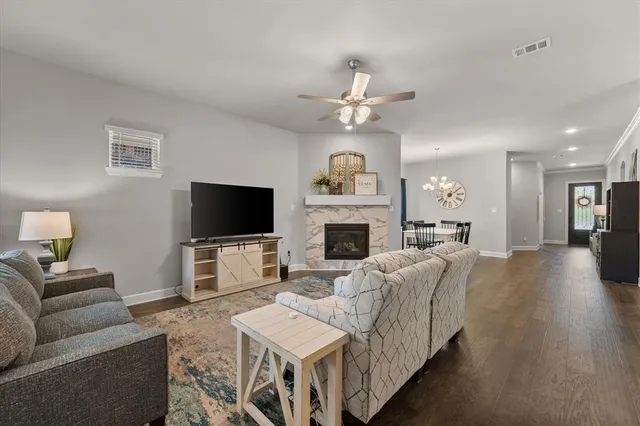 a living room with furniture a flat screen tv and a fireplace