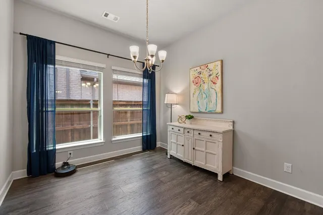 a view of a bedroom with wooden floor cabinet and windows