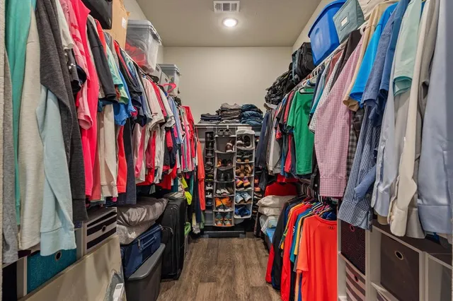 a view of walk in closet with clothes