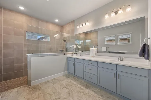a bathroom with a sink double vanity and a mirror