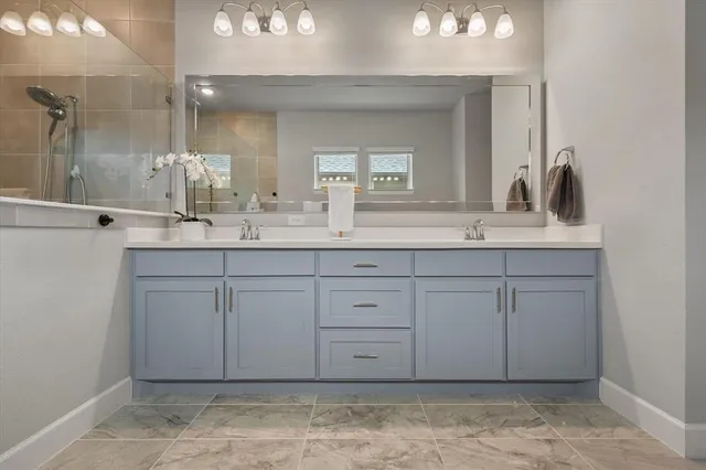 a bathroom with a sink vanity and mirror