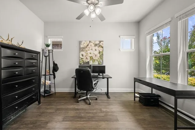a view of a workspace with furniture and a window
