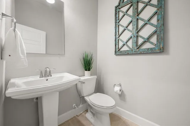 a bathroom with a sink mirror and toilet