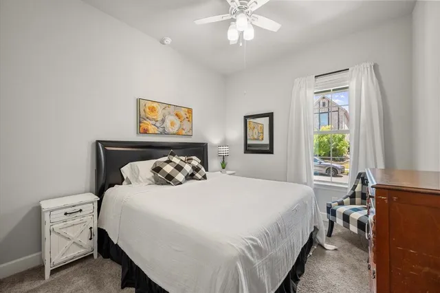 a bedroom with a bed and a window