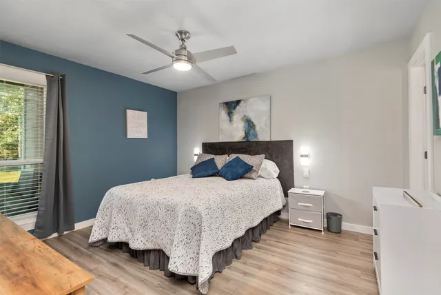 a bedroom with a bed and a chandelier