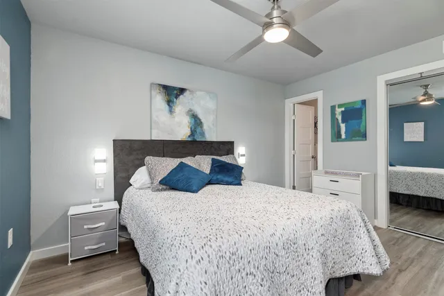 a bedroom with a bed and a chandelier