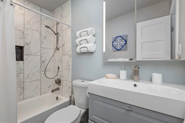 a bathroom with a sink toilet and shower