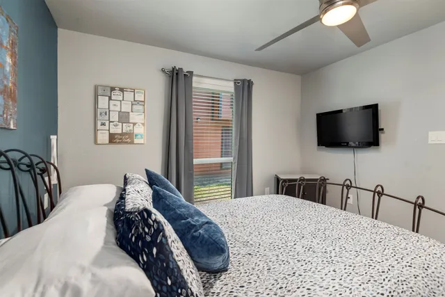 a bedroom with a bed and a flat screen tv