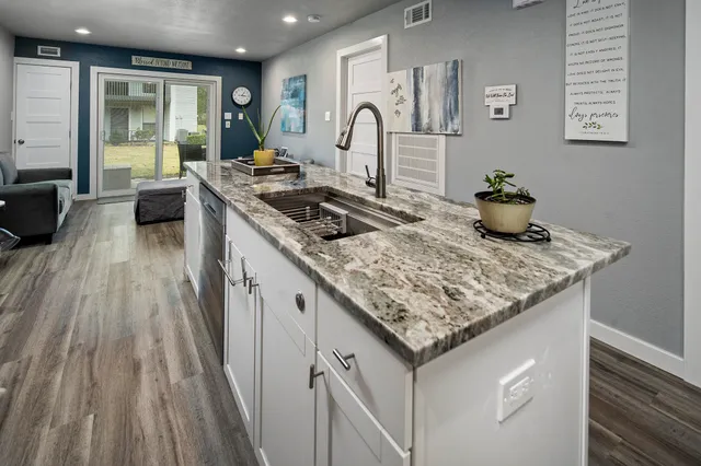 a kitchen with sink stove and cabinets
