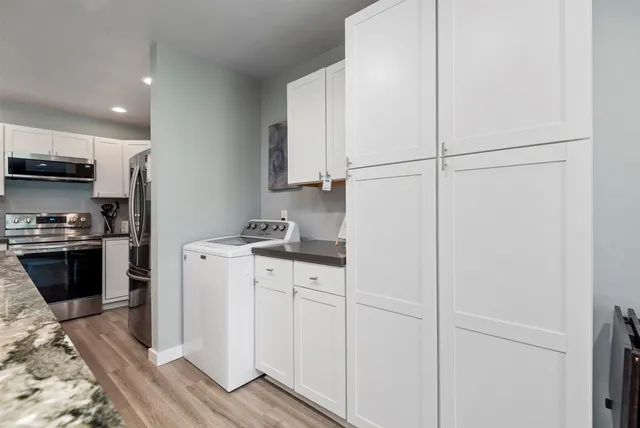 a kitchen with a refrigerator and a stove top oven