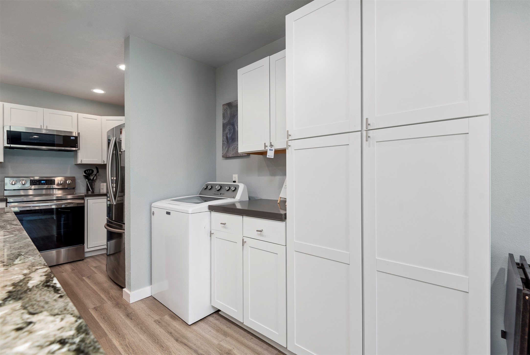 13151 Walden Road, Unit 195 Montgomery, TX 77356 - Photo 8 of 35 a kitchen with a refrigerator and a stove top oven