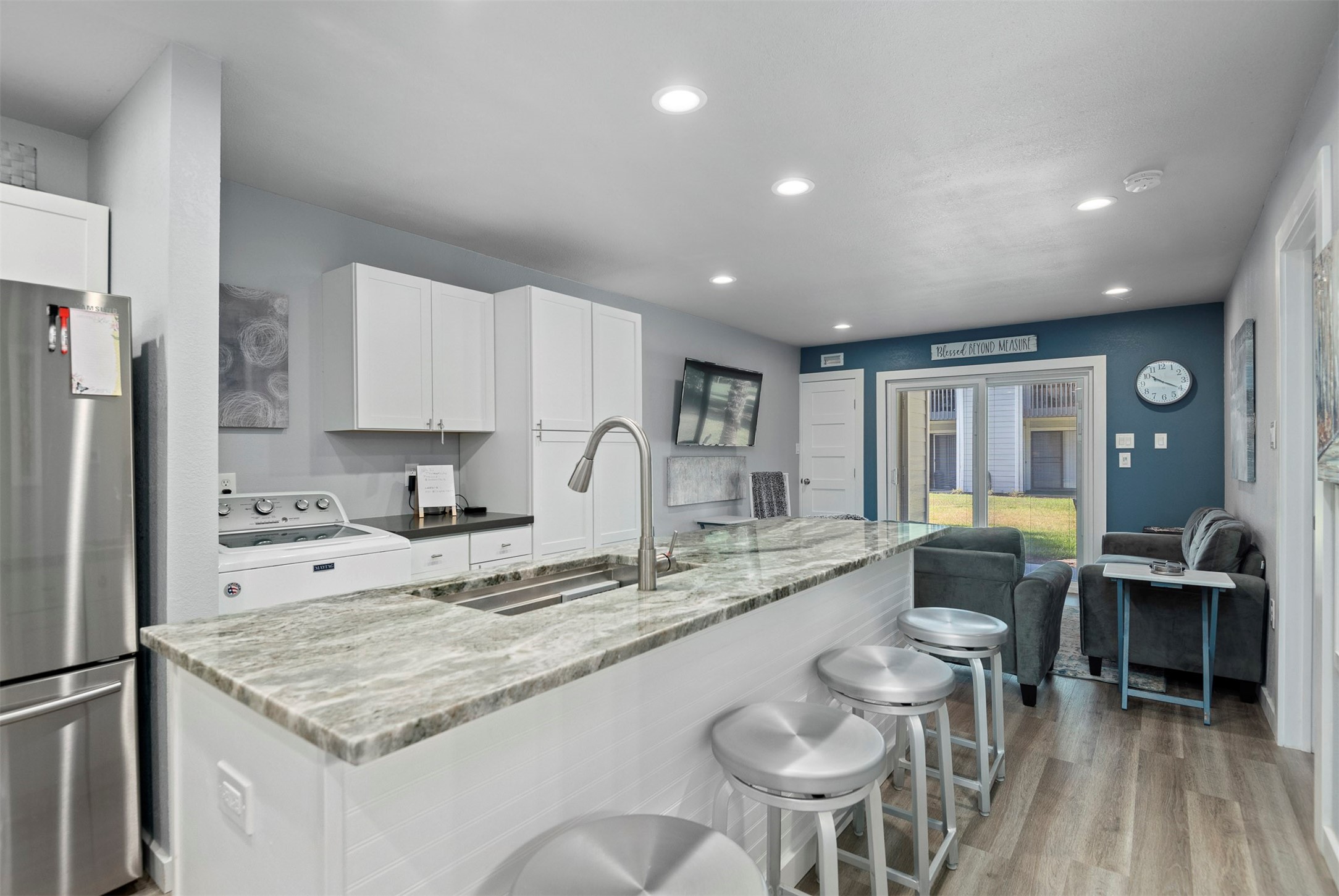 13151 Walden Road, Unit 195 Montgomery, TX 77356 - Photo 9 of 35 a kitchen with stainless steel appliances granite countertop a sink and a refrigerator