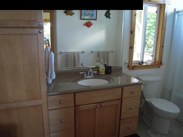 377 Ulaino Road, Unit KAWELA RIDGE LOT 7 Hana, HI 96713 - Photo 17 of 30 a bathroom with a granite countertop sink toilet and mirror