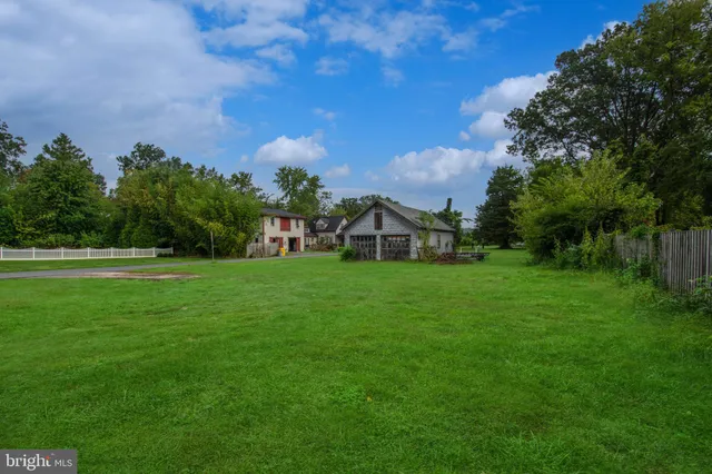 a house with green field in front of it