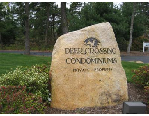 10 Shellback Way, Unit 10 Mashpee, MA 02649 - Photo 11 of 12 a sign of golf club on a wall under a tree