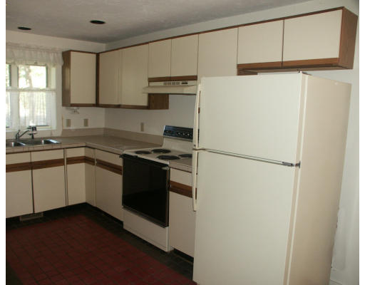 10 Shellback Way, Unit 10 Mashpee, MA 02649 - Photo 8 of 12 a kitchen with a refrigerator sink and cabinets