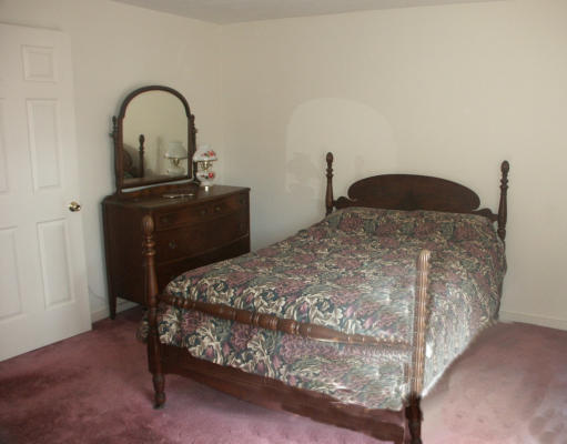 10 Shellback Way, Unit 10 Mashpee, MA 02649 - Photo 10 of 12 a bedroom with a bed and a dresser