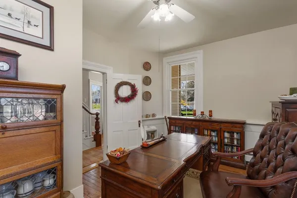 a kitchen with stainless steel appliances granite countertop a stove a refrigerator a sink a dining table and chairs with wooden floor