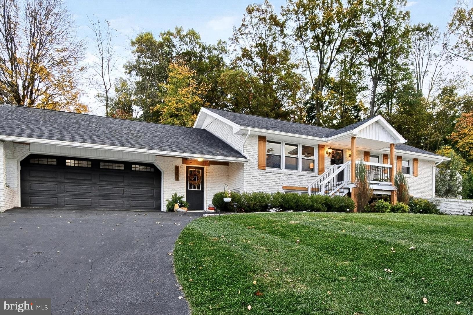 9263 East Springfield Road Seven Valleys, PA 17360 - Photo 1 of 20 a front view of a house with a yard and garage