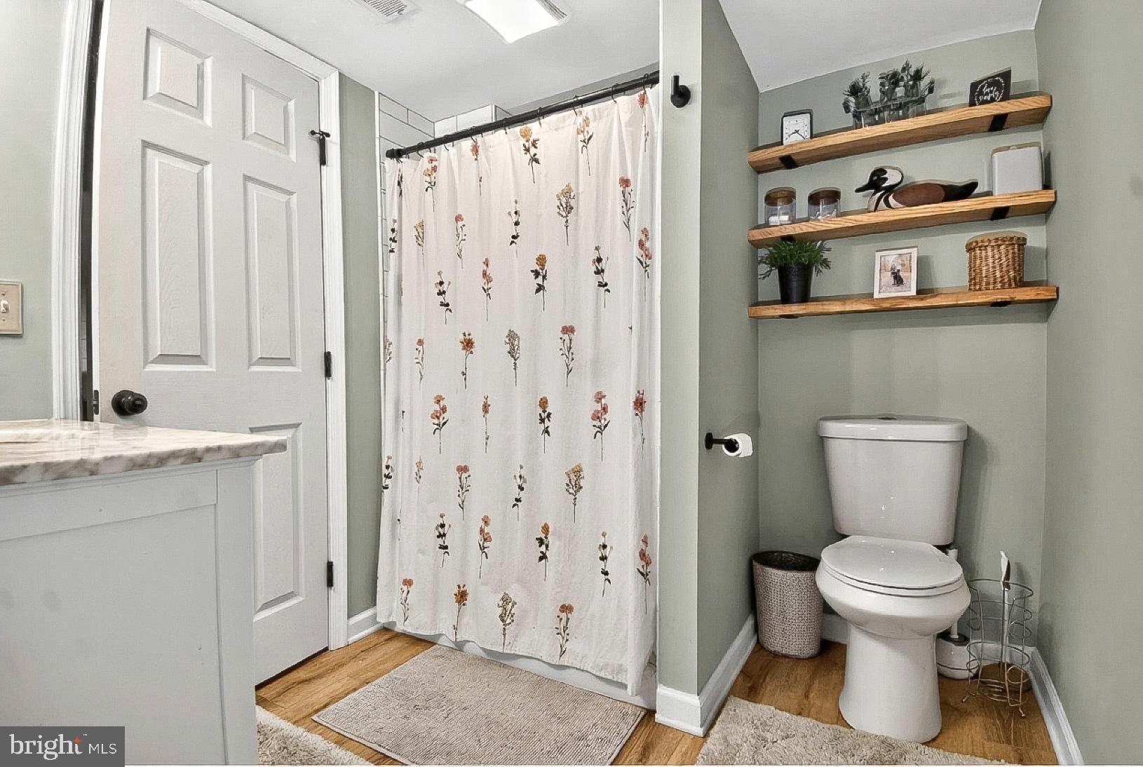 9263 East Springfield Road Seven Valleys, PA 17360 - Photo 14 of 20 a bathroom with a toilet a sink and a shower curtain