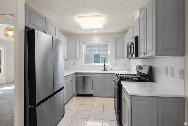 463 North 2400 West, Unit 7 Springville, UT 84663 - Photo 11 of 22 Kitchen featuring light gray cabinetry, white countertops, stainless steel appliances, and tile flooring