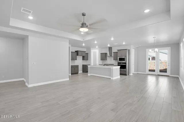 a view of a kitchen with a sink and a refrigerator