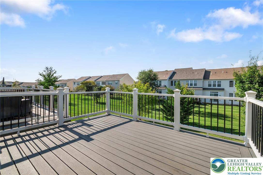 8455 Starling Road Breinigsville, PA 18031 - Photo 21 of 24 An inviting deck offers serene neighborhood green space views, perfect for outdoor relaxation.
