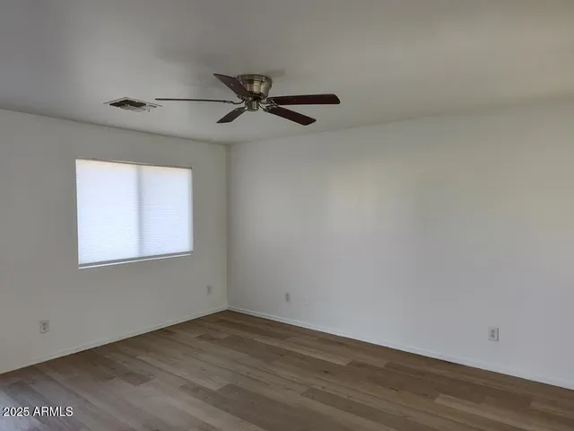 a kitchen with a stove cabinets and wooden floor
