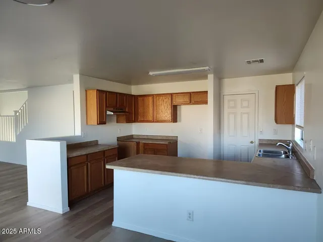 a kitchen with a sink and a window