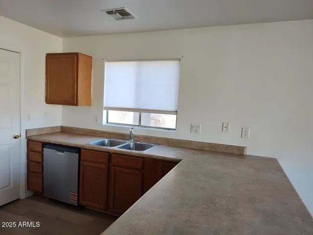 a kitchen with sink and cabinets