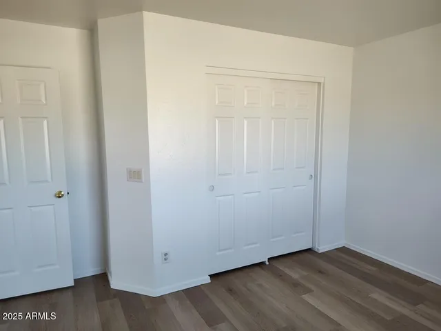 a view of a room with wooden floor