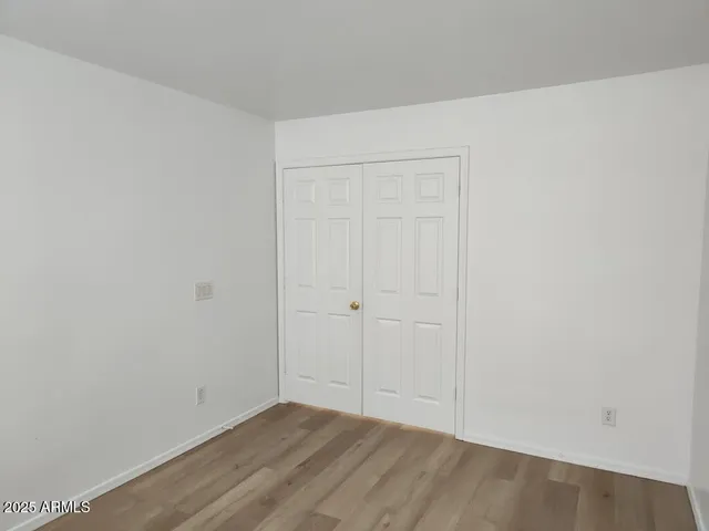 a view of an entryway with wooden floor and door