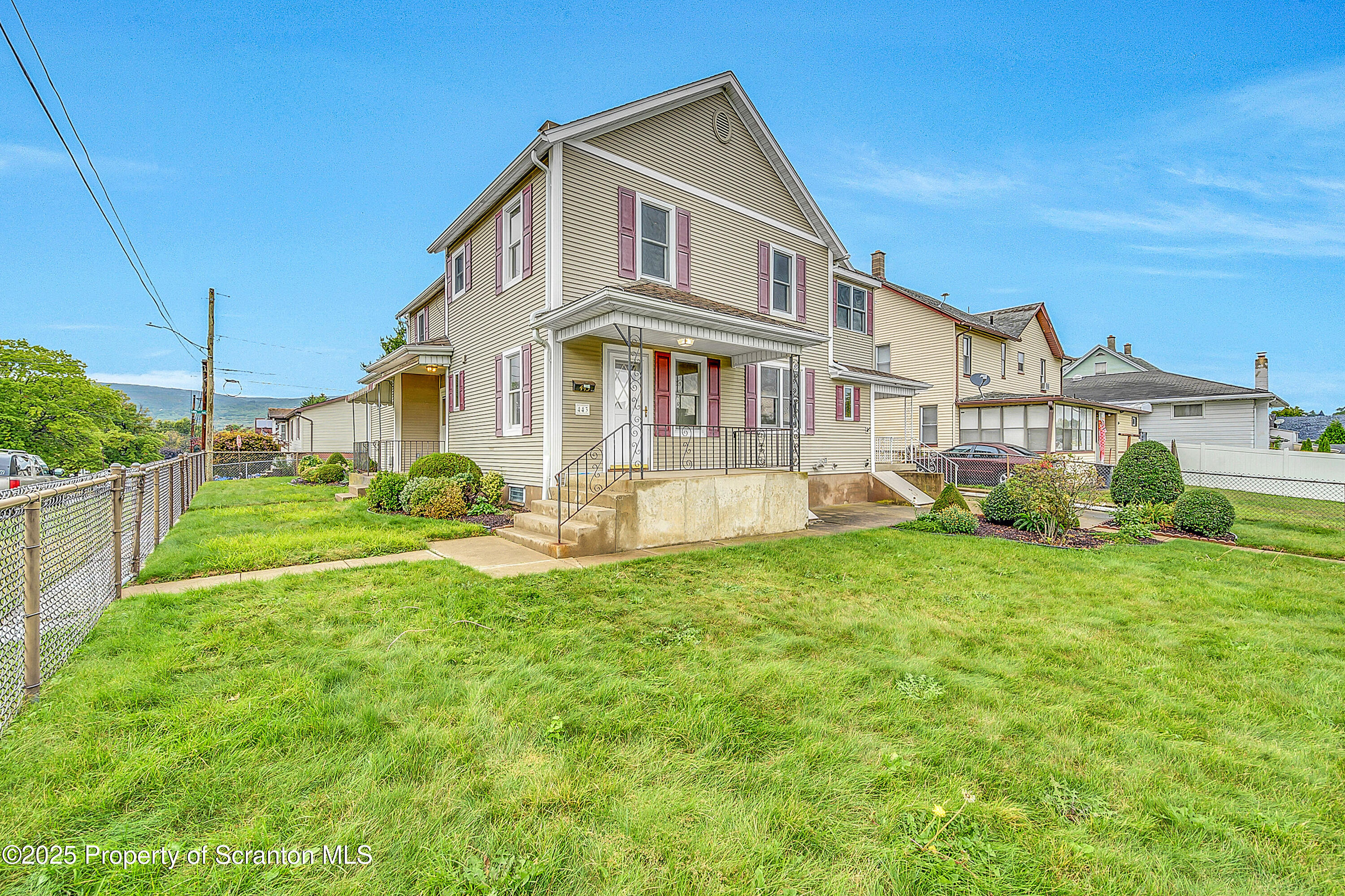 443 14th Avenue, Unit REAR Scranton, PA 18504 - Photo 2 of 16 a front view of a house with a yard table and chairs