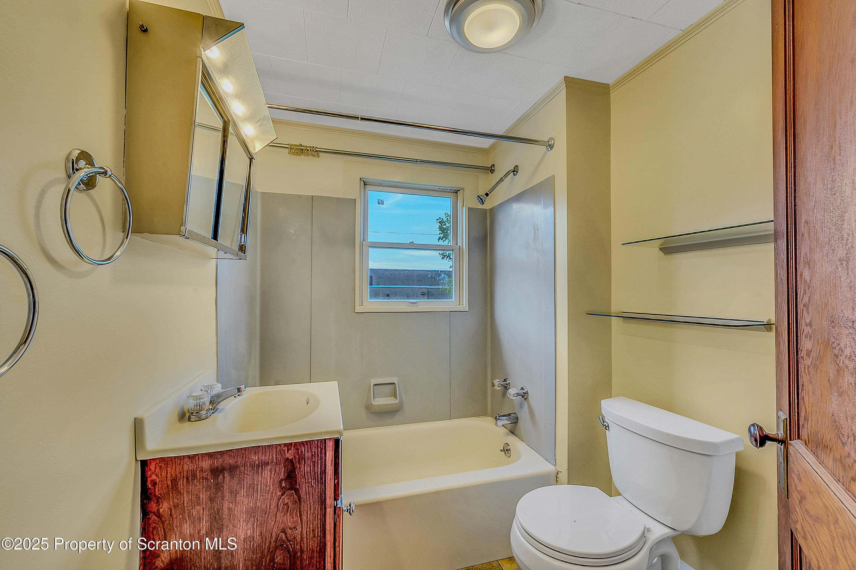 443 14th Avenue, Unit REAR Scranton, PA 18504 - Photo 9 of 16 a bathroom with a toilet sink vanity tub and shower