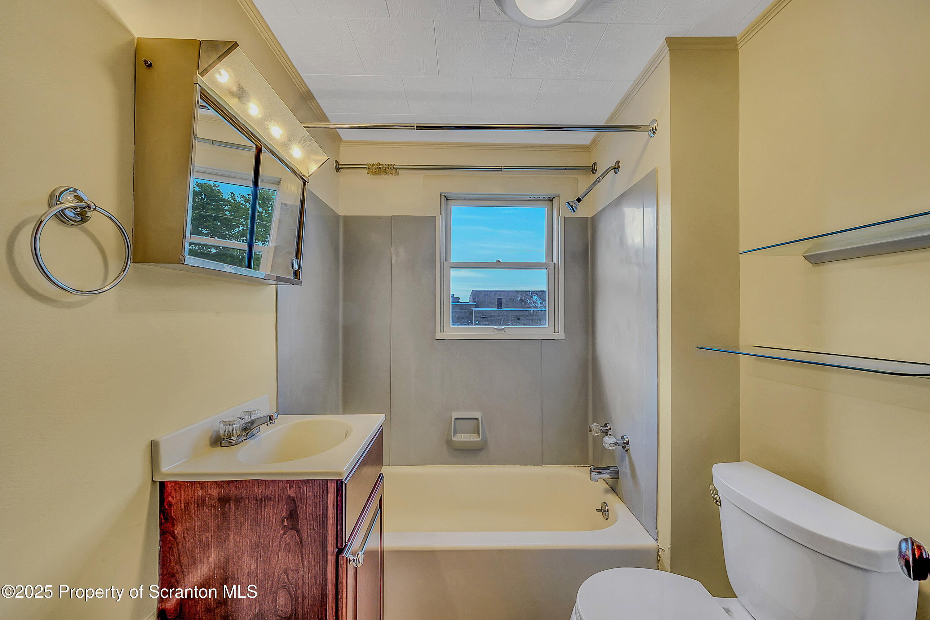 443 14th Avenue, Unit REAR Scranton, PA 18504 - Photo 10 of 16 a bathroom with a sink a toilet and shower