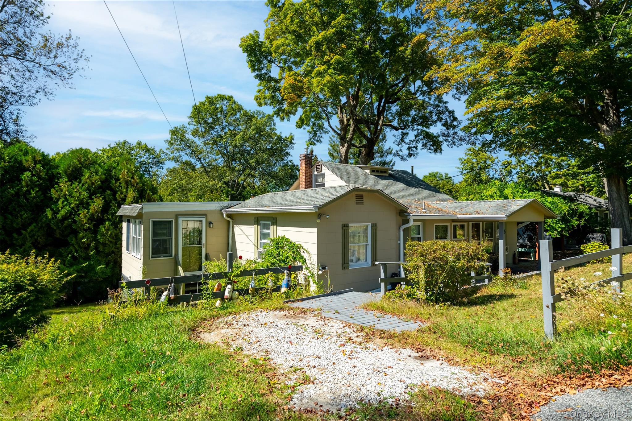 Ranch-style home with a chimney and a shingled roof