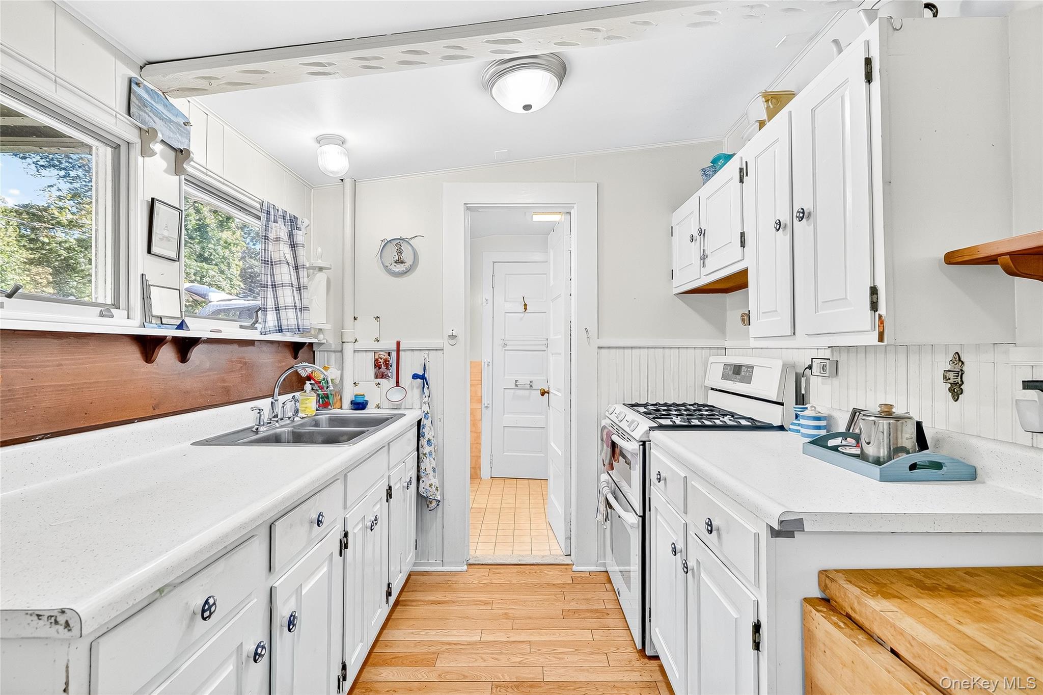 5 Orchard Road North Salem, NY 10509 - Photo 18 of 47 Kitchen with white cabinets, double oven range, light wood-type flooring, ornamental molding, and wainscoting