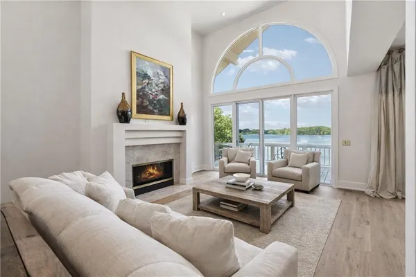 a kitchen with stainless steel appliances granite countertop a sink counter space and a view of living room