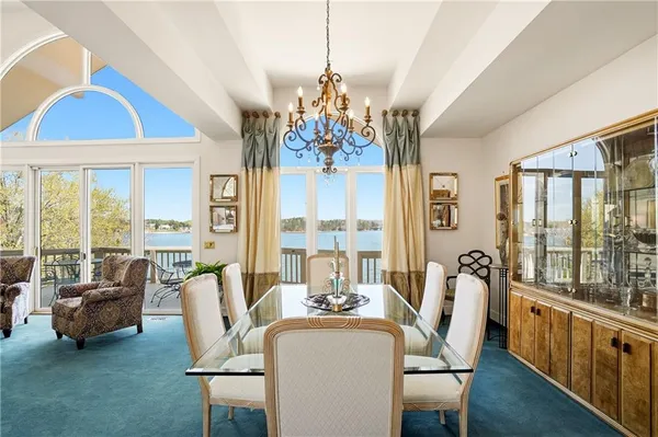 a dining area with a table chairs and a kitchen view