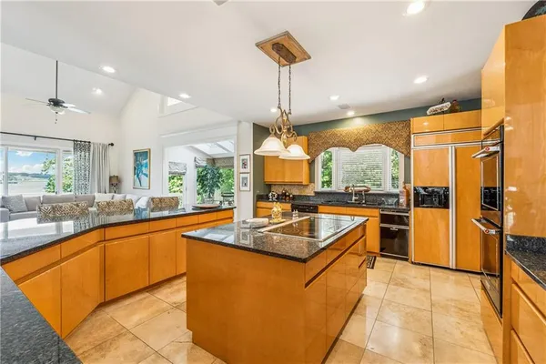 a living room with furniture a flat screen tv and a table