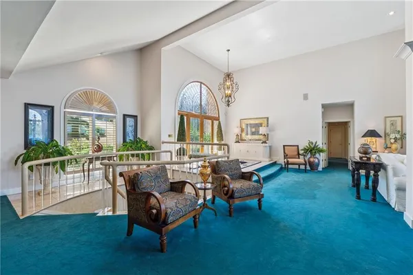 a kitchen with stainless steel appliances granite countertop a stove and a view of living room